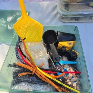 Sensory bin. Educational toy perfect as a birthday gift. Escavator trucks diggin